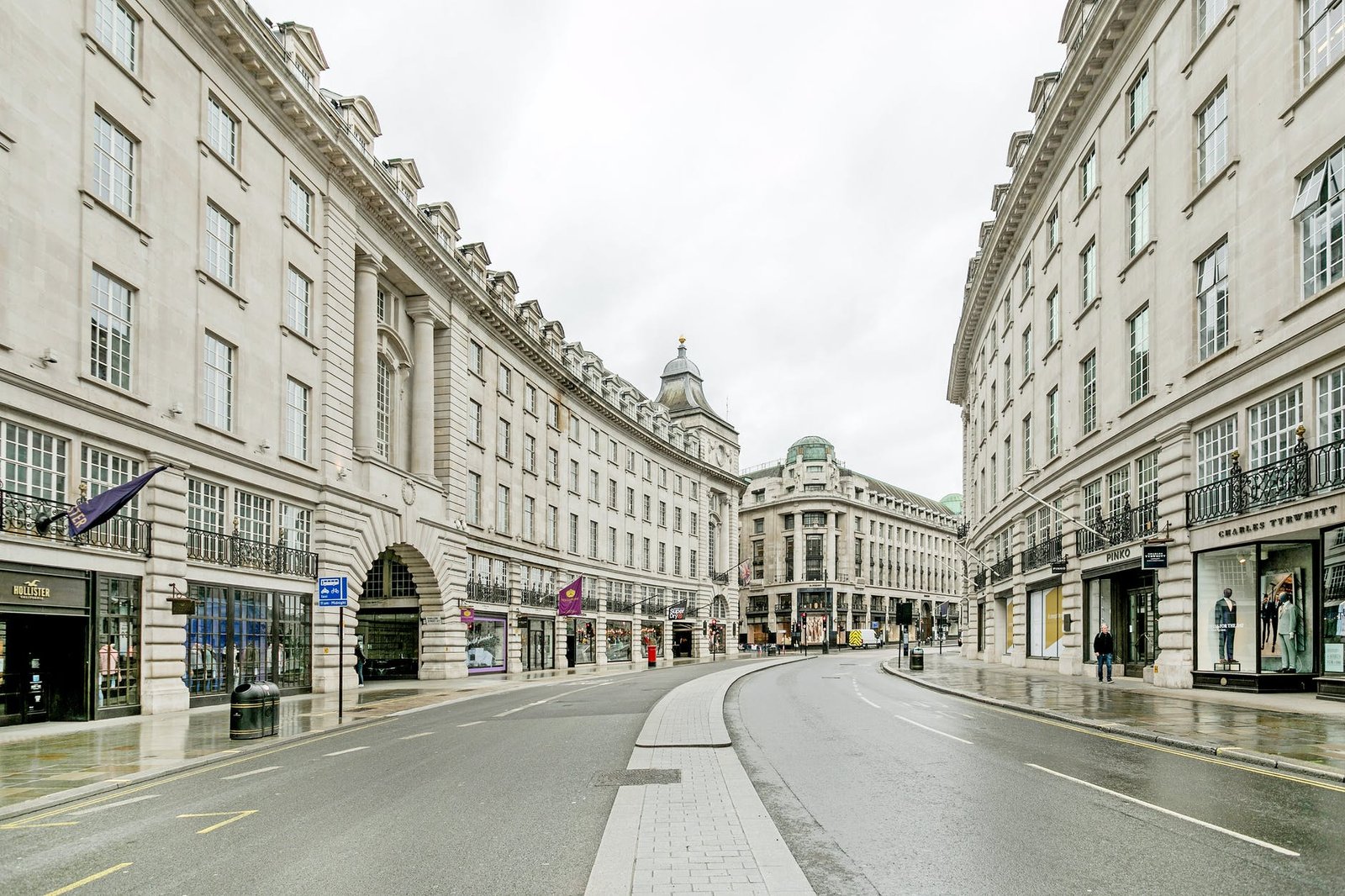 photo of an empty road between old buildings