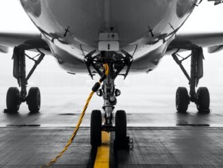 gray air vehicle with yellow coated cable around docking wheels