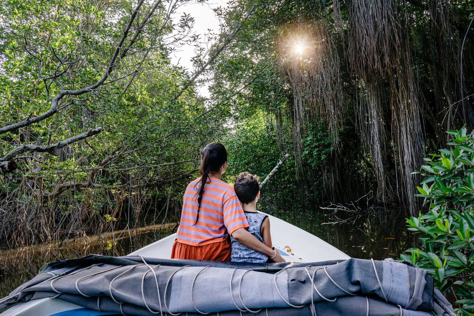 backview of mother and son on a boat