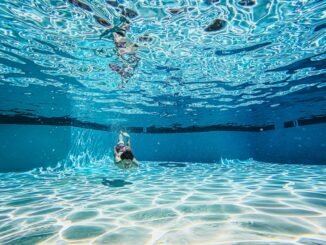 a boy swimming underwater
