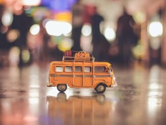 selective focus photography of yellow school bus scale model