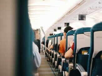 people sitting on blue seats inside an airplane