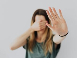 woman covering her face with her hands