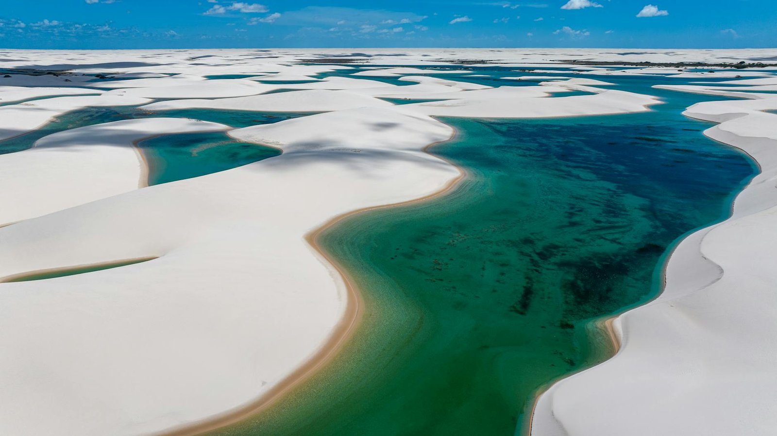aerial view of the white sand dunes and water