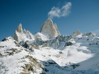 peak of the mountains covered in snow under a blue sky