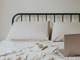 laptop and notes on bed