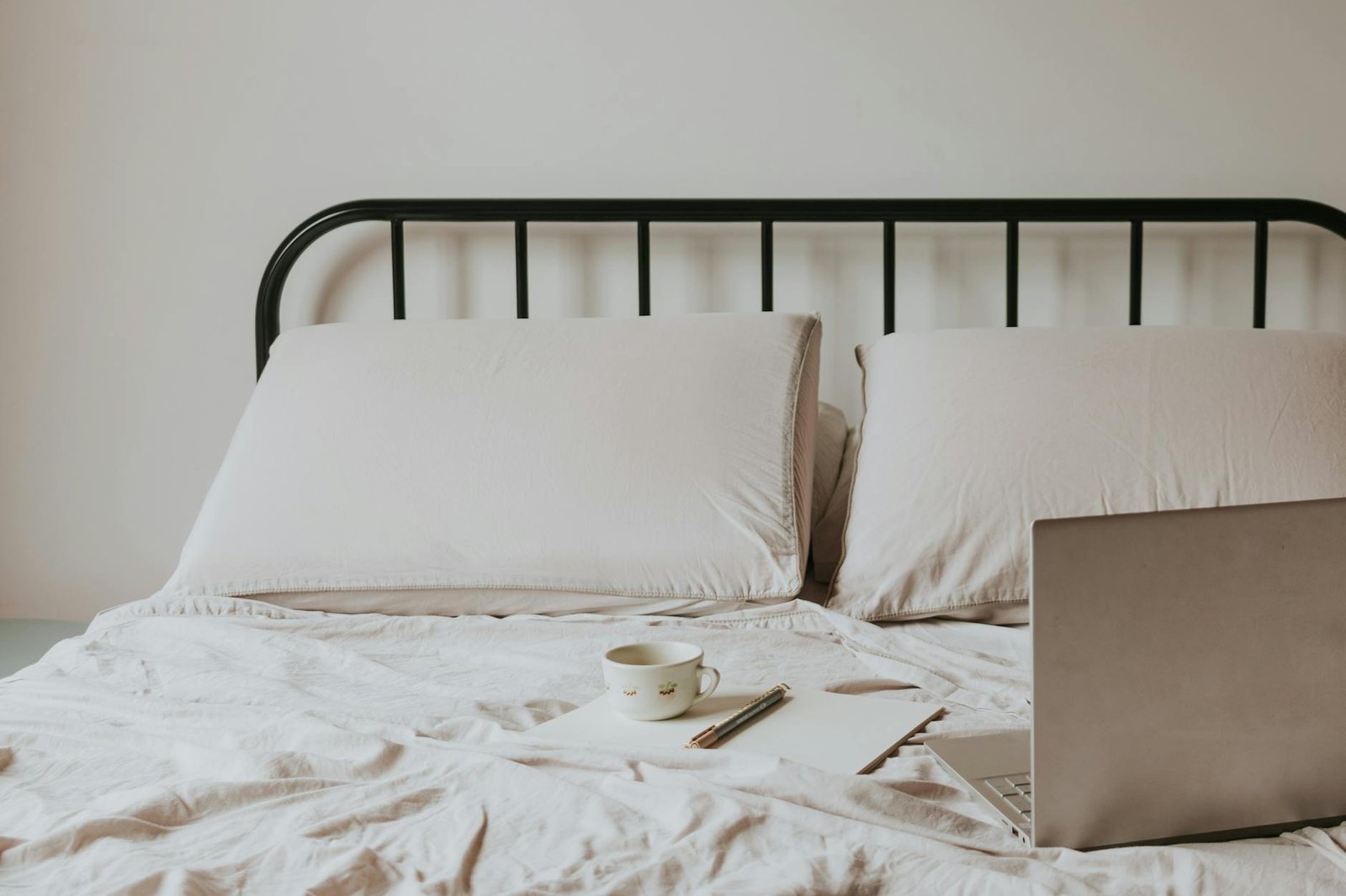 laptop and notes on bed