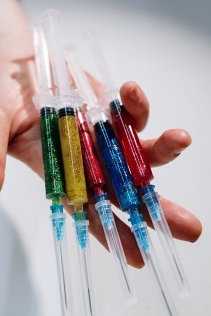 close up photo of person holding syringe