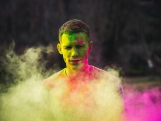 man painted with green and purple paints photo