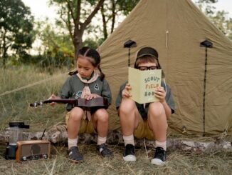 scouts sitting beside a tent