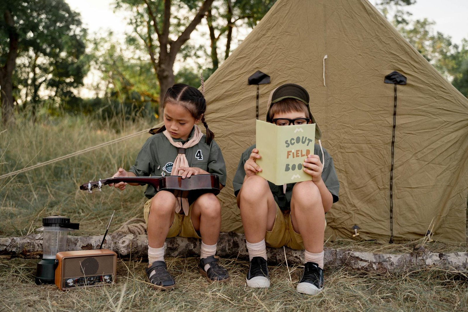 scouts sitting beside a tent