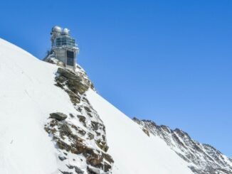 observation on high snowy mount under blue sky
