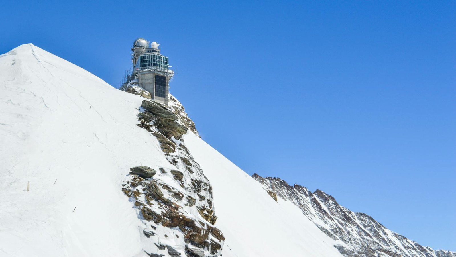observation on high snowy mount under blue sky